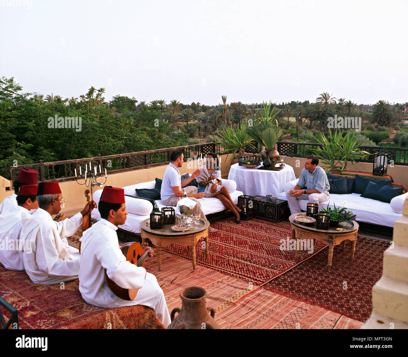 Guests on hotel balcony Moroccan musicians Exteriors hotels arabian arabic moorish outdoor entertaining Stock Photo