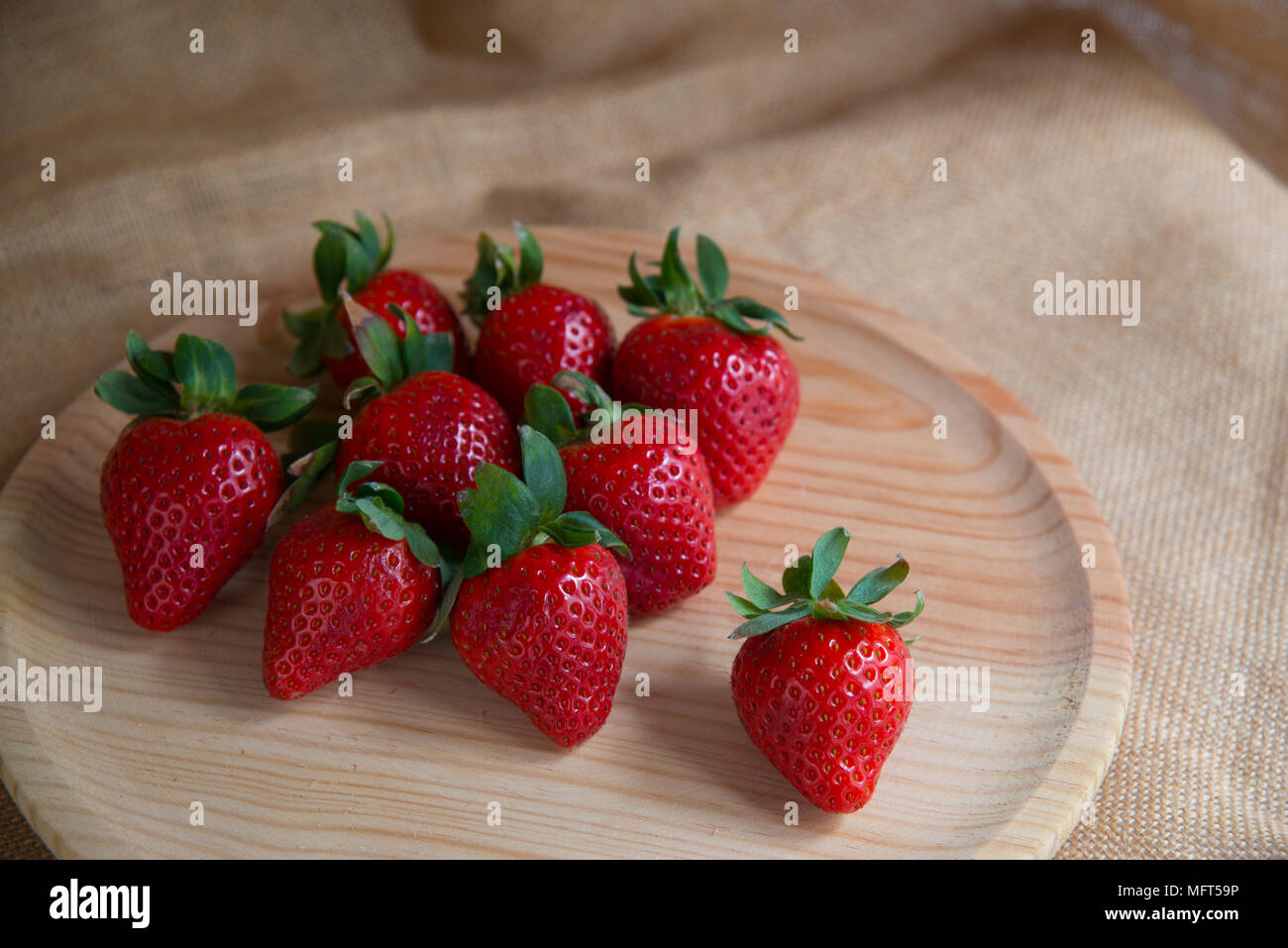 Strawberries on wooden dish. Still life Stock Photo - Alamy