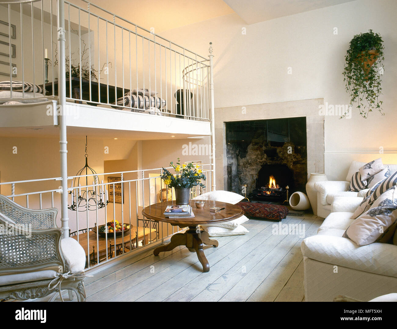 A Traditional White Sitting Room With Split Level Balconies