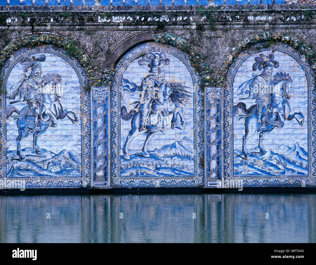 Exterior of tiled mural walls above surface of lake Stock Photo