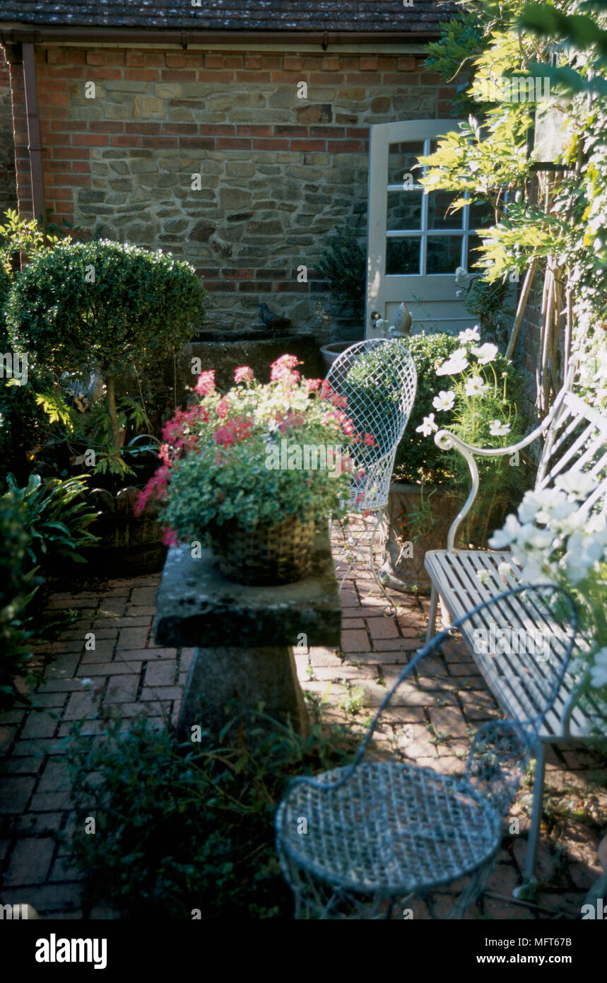 A Detail Of A Country Garden With A Paved Patio Area Wrought Iron
