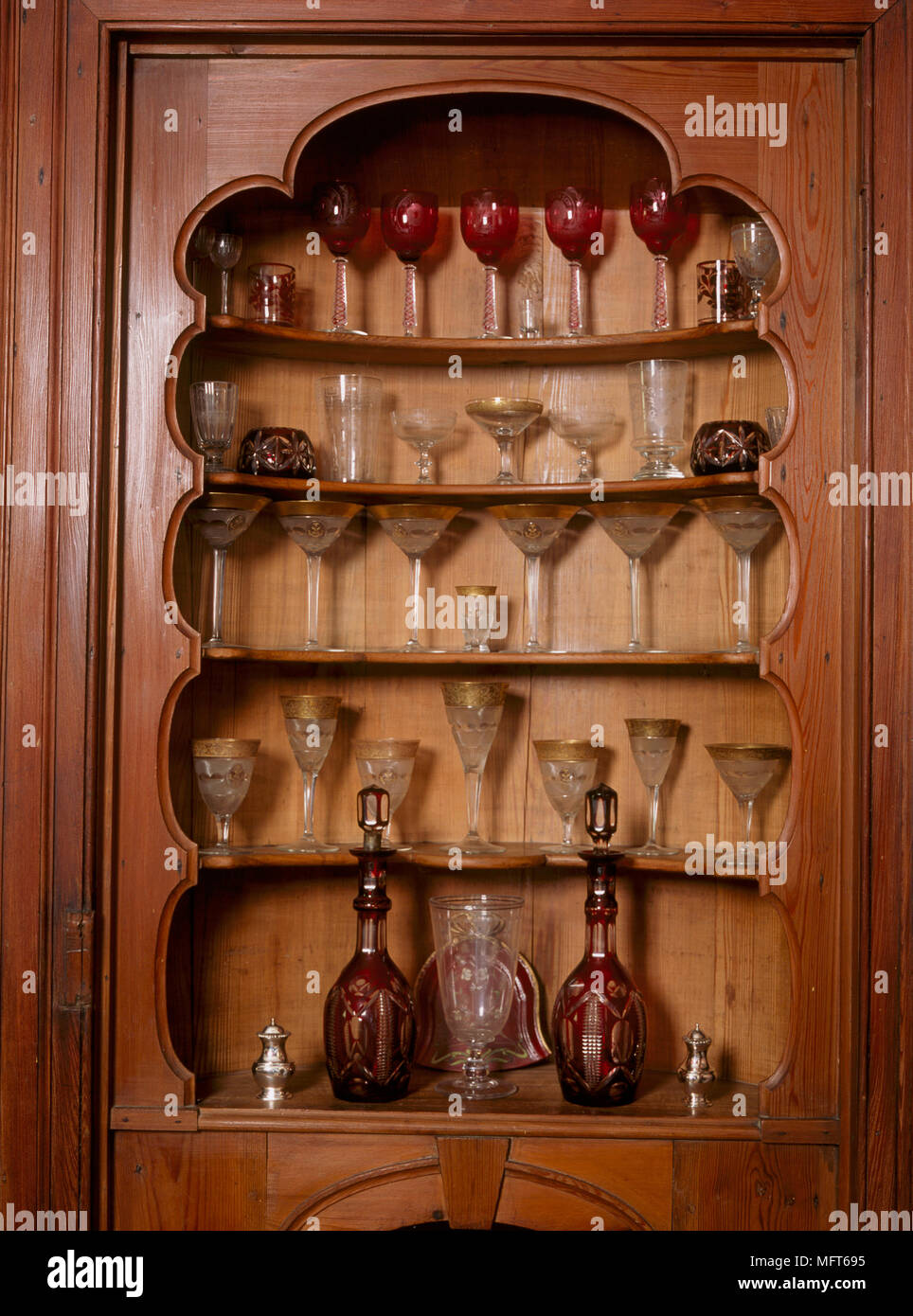 A detail of a traditional shelving unit with a display of glasses and decanters, Stock Photo