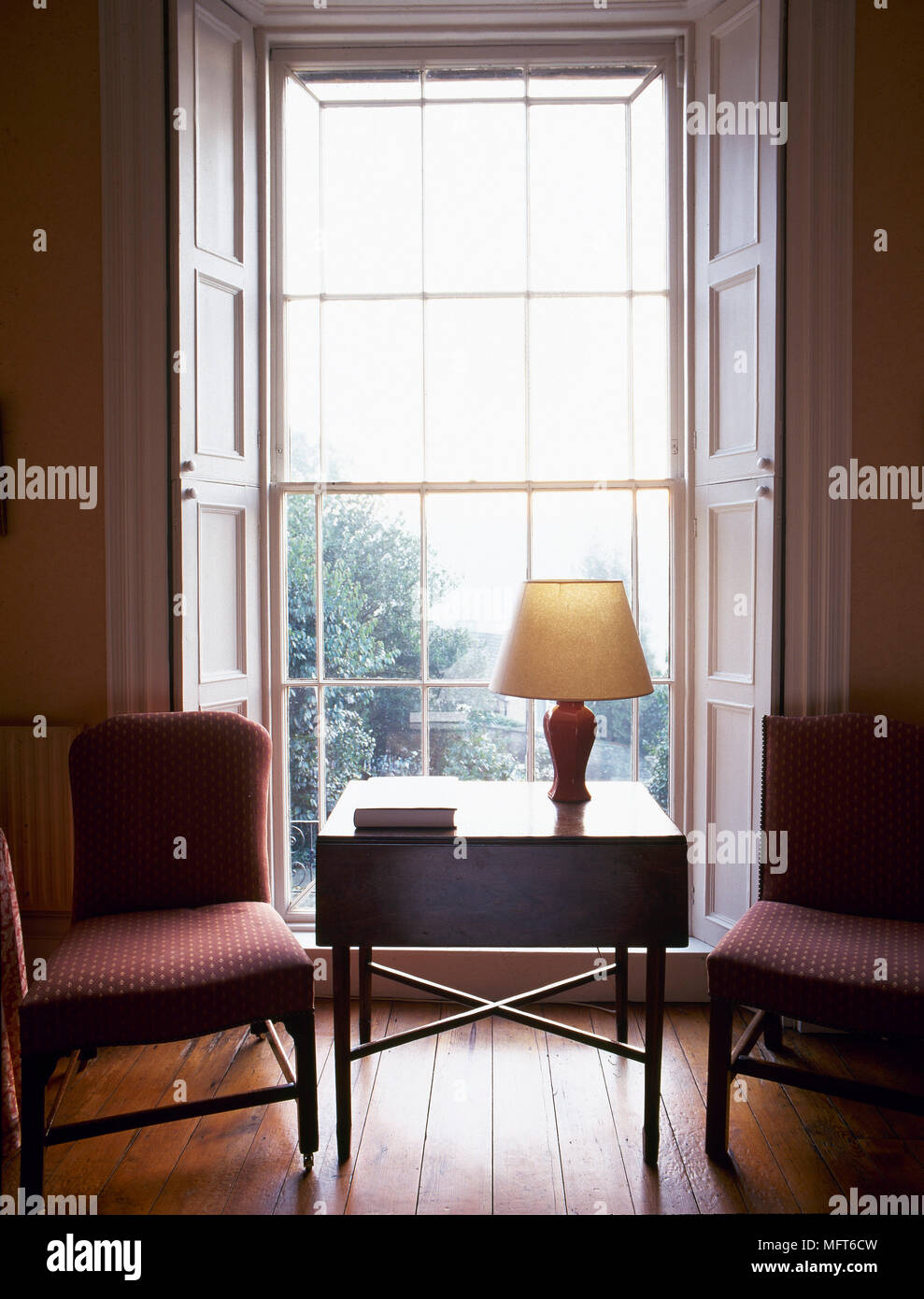 Traditional sitting room with a wooden side table and upholstered ...