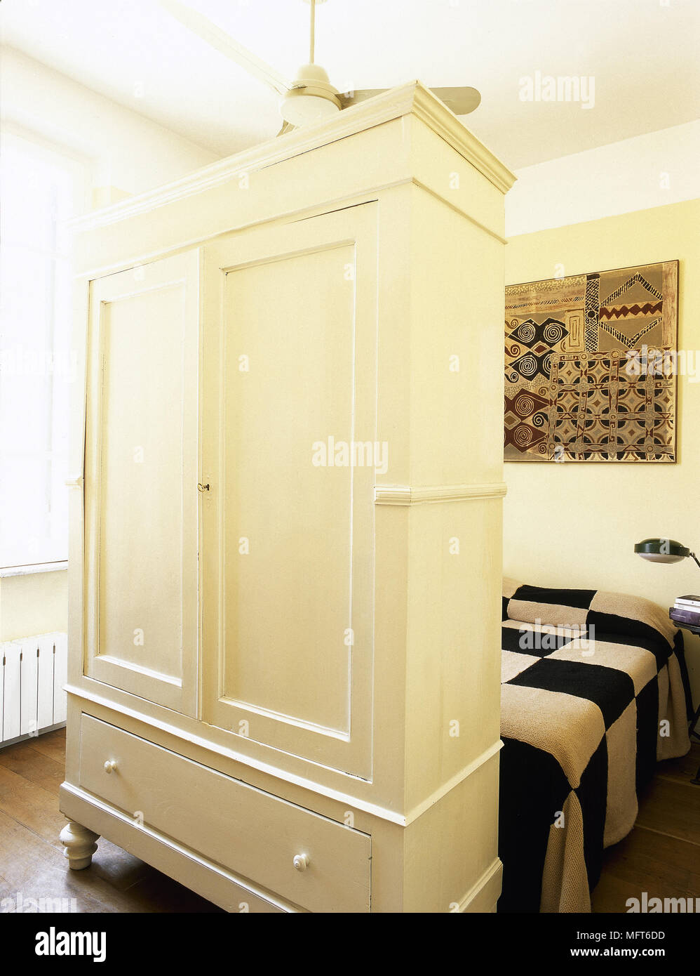 Freestanding painted wardrobe at foot of double bed Stock Photo Alamy