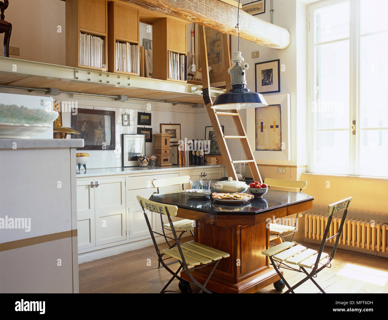 Dining Table And Chairs In Open Plan Room With Ladder To Upper