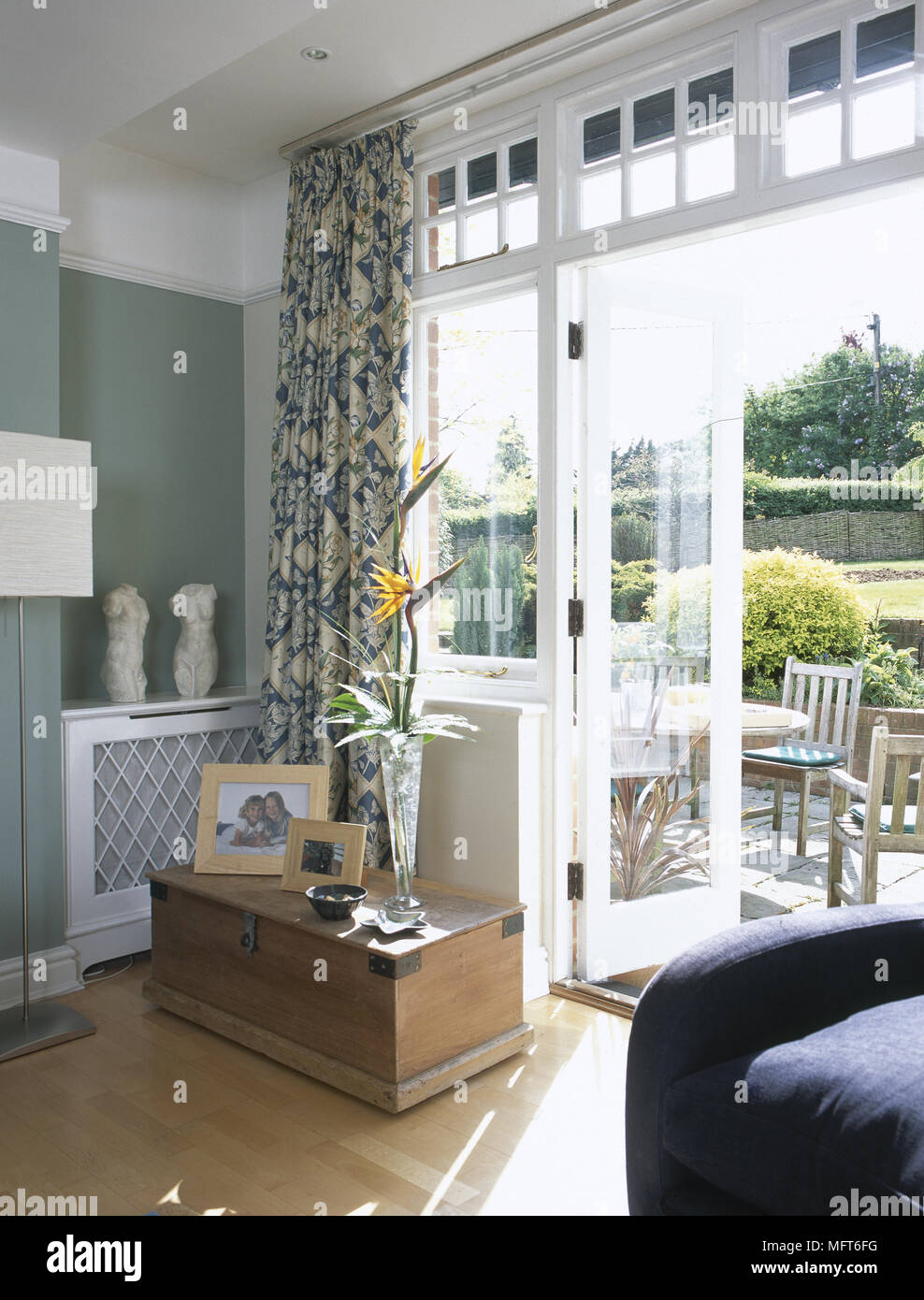 Modern Sitting Room With Wood Floor Blanket Chest Patterned