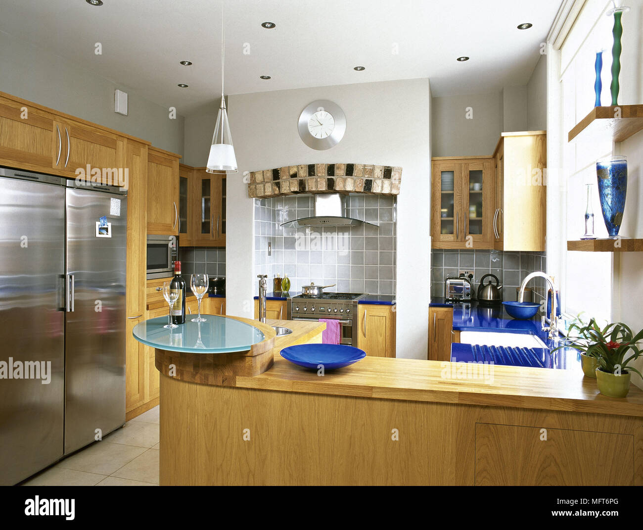 https://c8.alamy.com/comp/MFT6PG/modern-kitchen-wood-units-stainless-steel-fridge-interiors-kitchens-MFT6PG.jpg