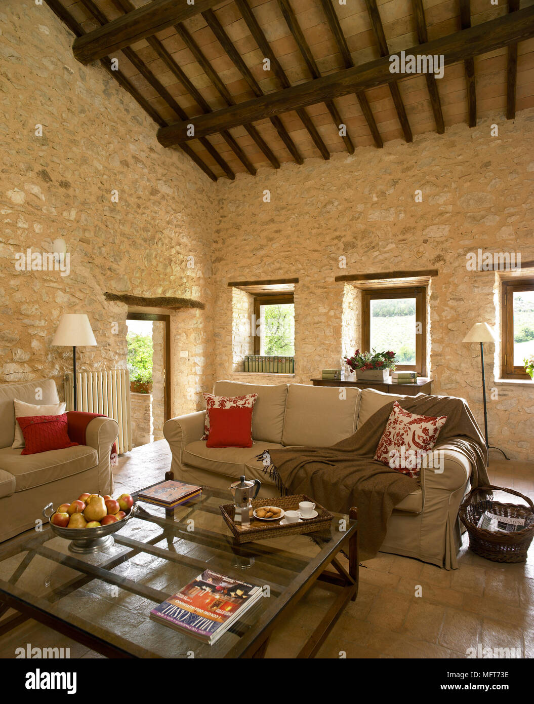 A Country Sitting Room With Exposed Rustic Stone Walls And