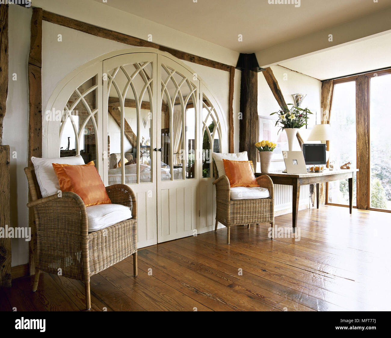A Country Style Sitting Room With Hard Wood Floor Beams