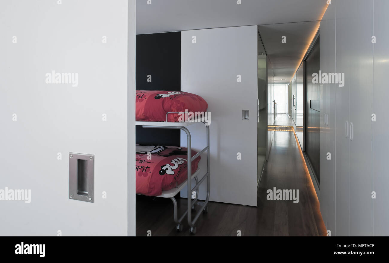 View Through Open Sliding Door To Metal Bunk Beds With Red