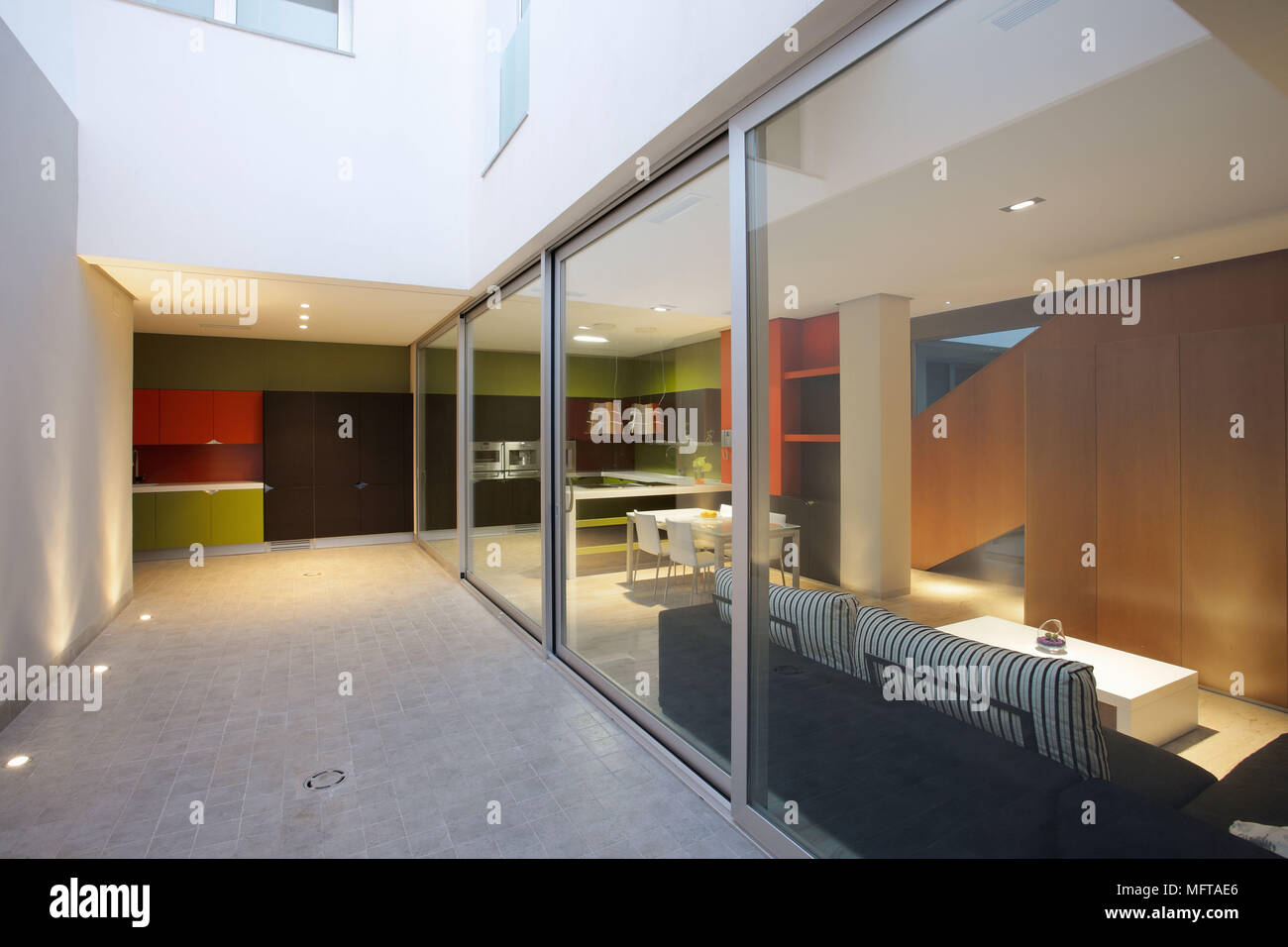 View Through Floor To Ceiling Windows To Contemporary Red And