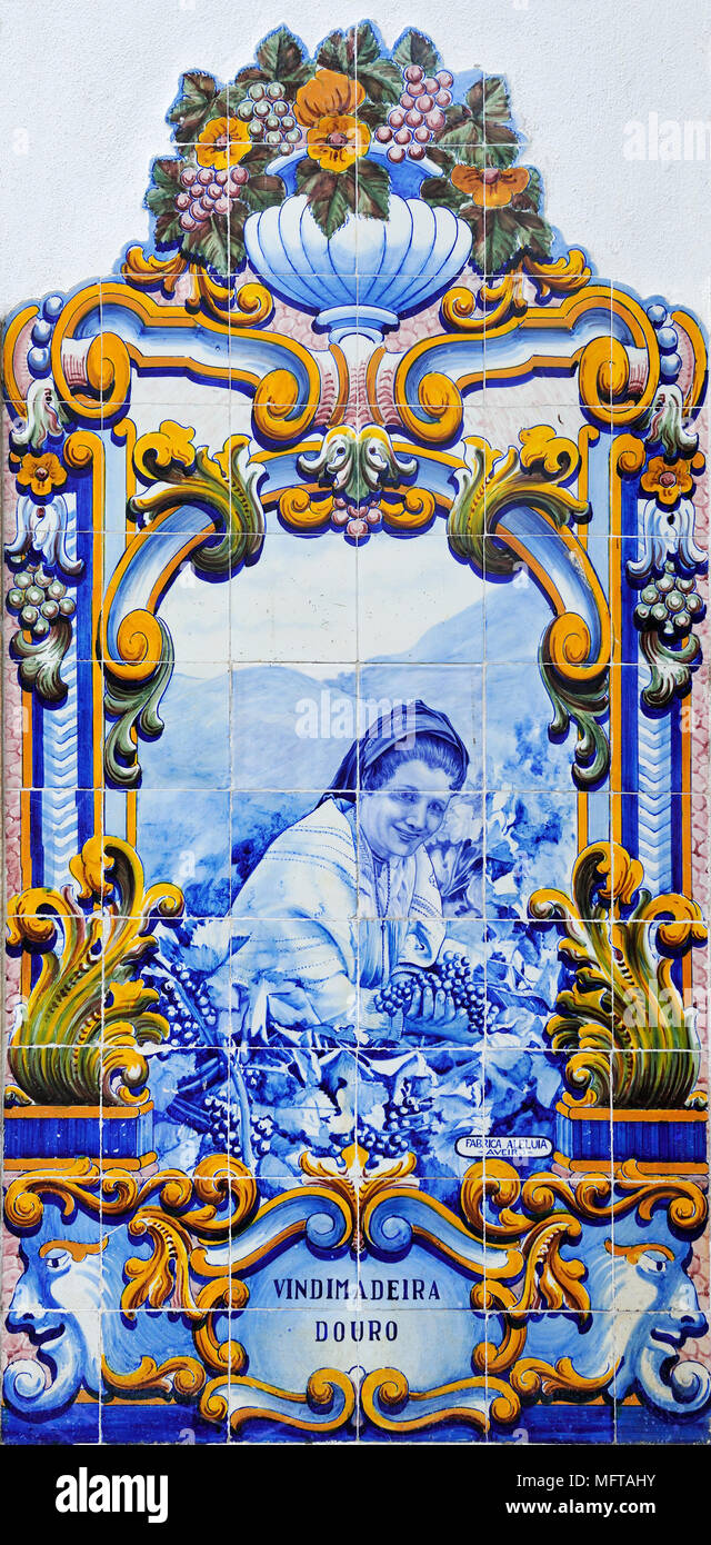 Traditional blue tiles (Azulejos) showing the work related with the Port Wine. Railway station of Pinhão, Douro region. A Unesco World Heritage Site,  Stock Photo