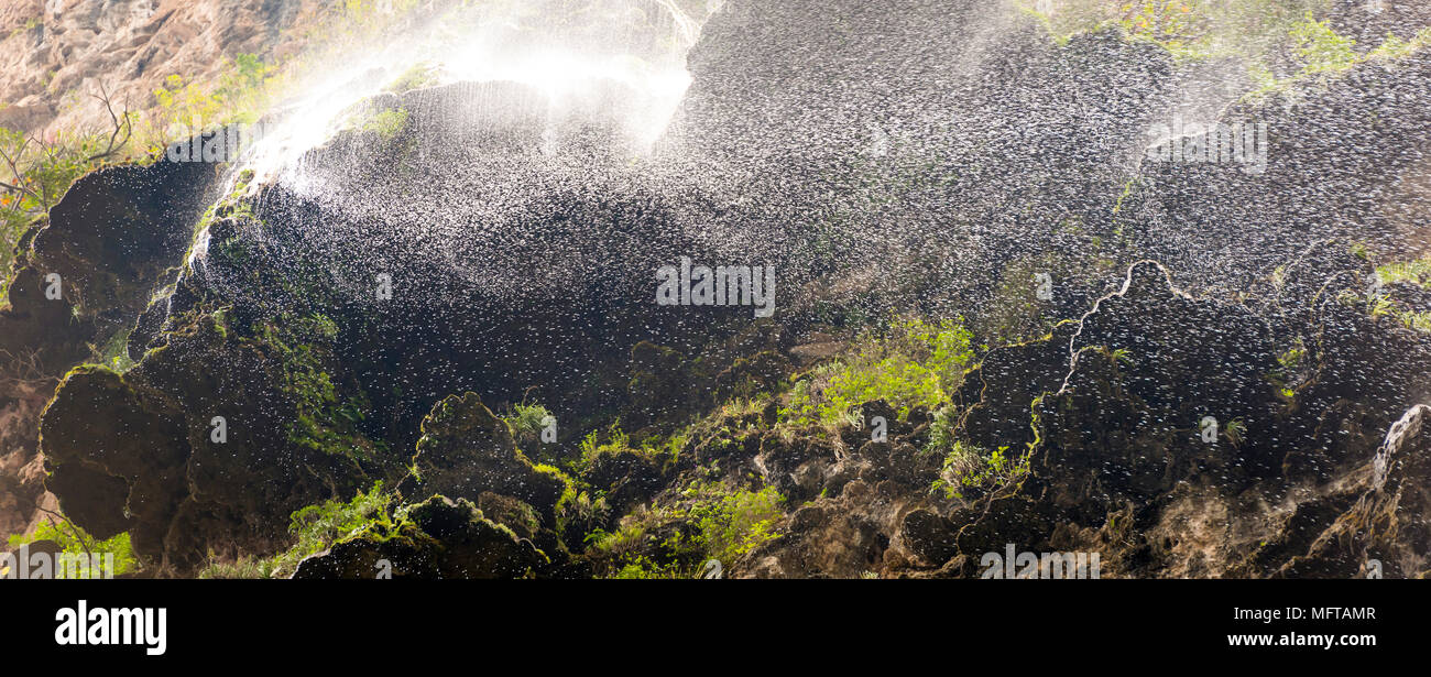 Abstract water droplets waterfall background with green moss Stock Photo