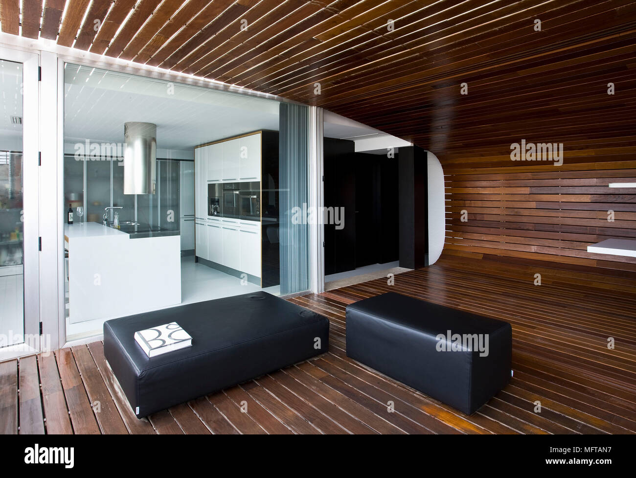 Black Leather Seating In Modern Open Plan Wood Panelled Room With