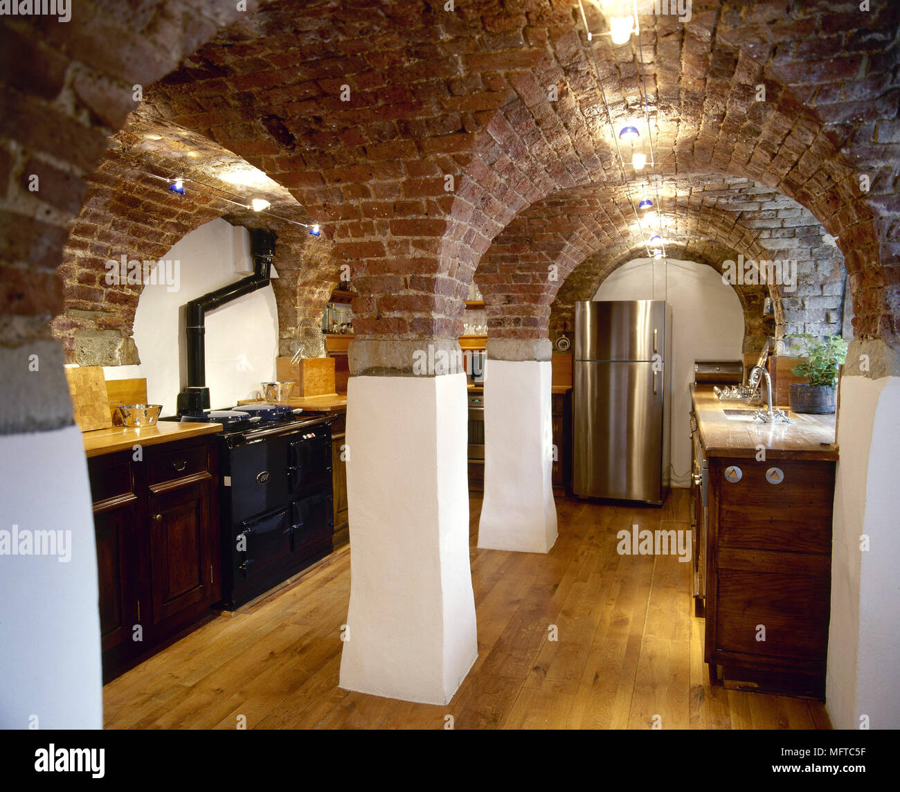 Rustic Kitchen In Converted Cellar With Exposed Brickwork