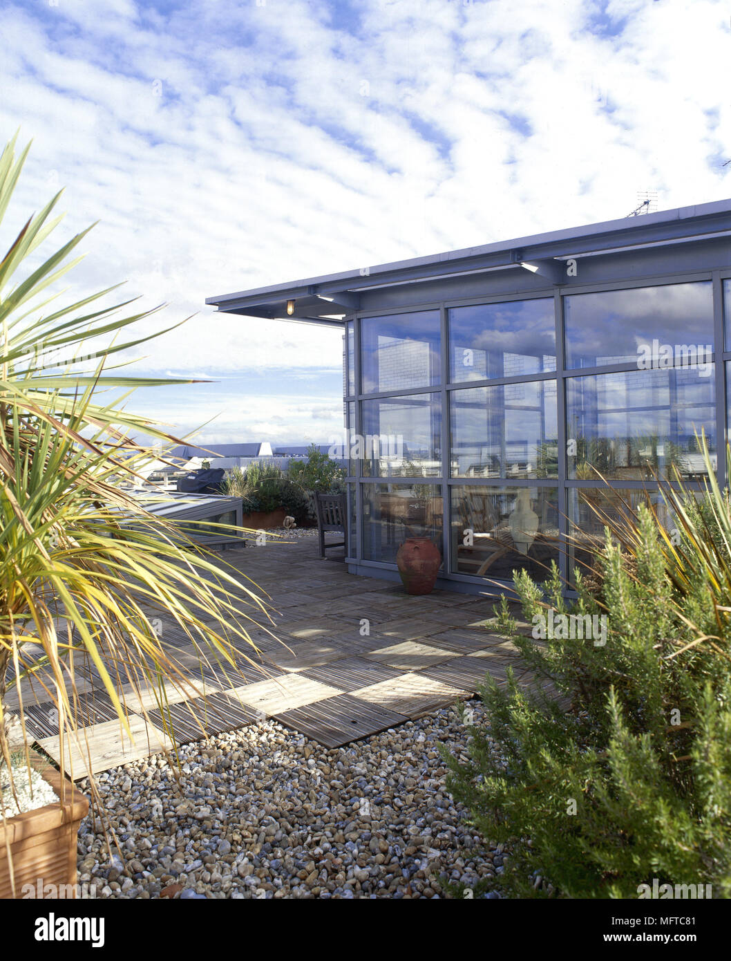 glass patio walls on Exterior Of A Modern House With Glass Walls Tiled Patio And Potted Plants Stock Photo Alamy