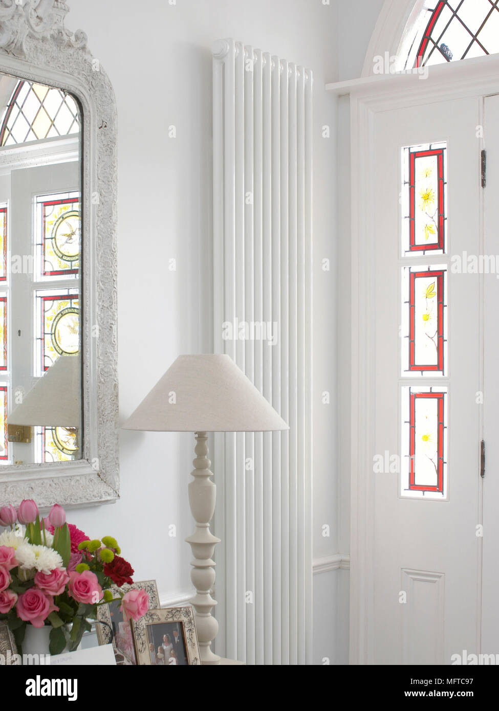 Wall mounted vertical radiator next to front door Stock Photo - Alamy