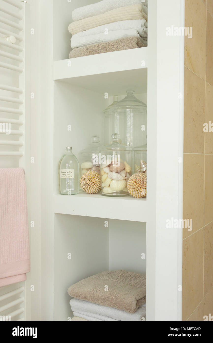 Glass jars in recessed shelving Stock Photo Alamy