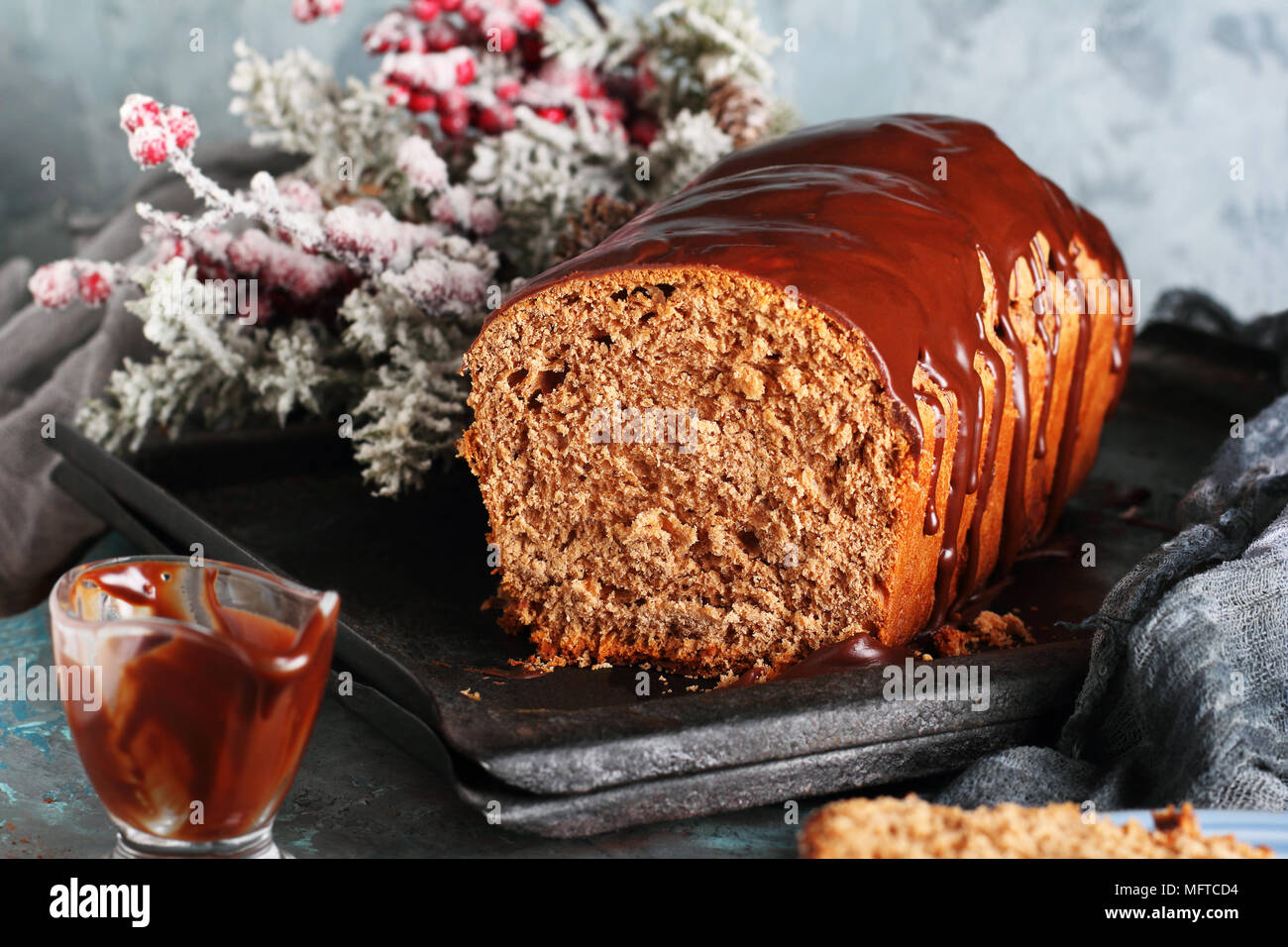 cut of homemade chocolate bread with chocolate icing, in New Year's decorations Stock Photo