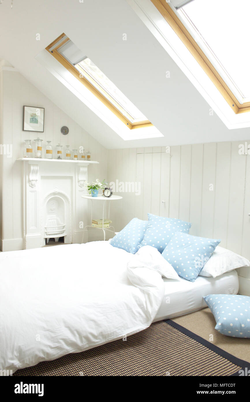 Double bed in attic room with skylight windows Stock Photo Alamy