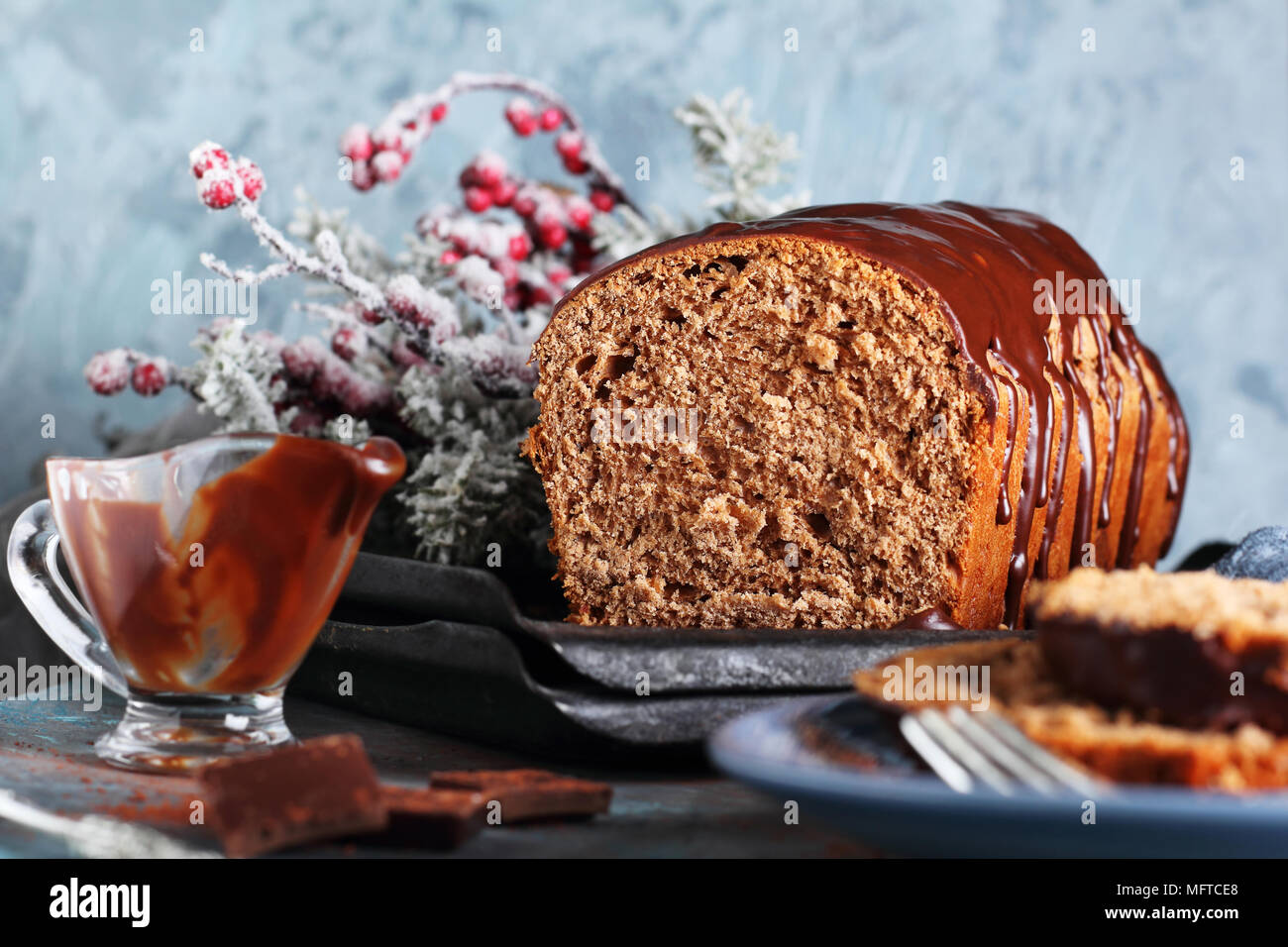 cut of homemade chocolate bread with chocolate icing, in New Year's decorations Stock Photo