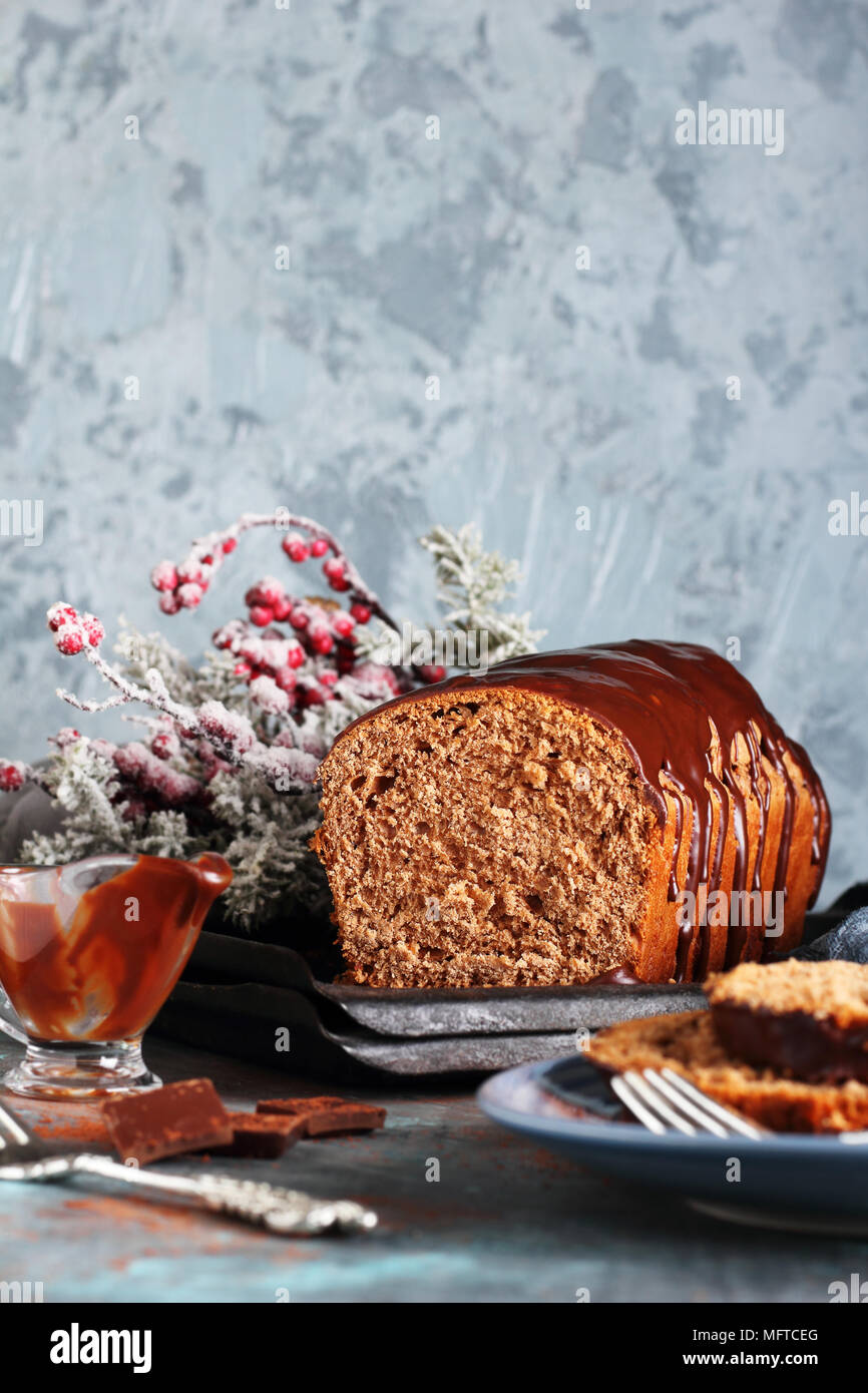 cut of homemade chocolate bread with chocolate icing, in New Year's decorations Stock Photo
