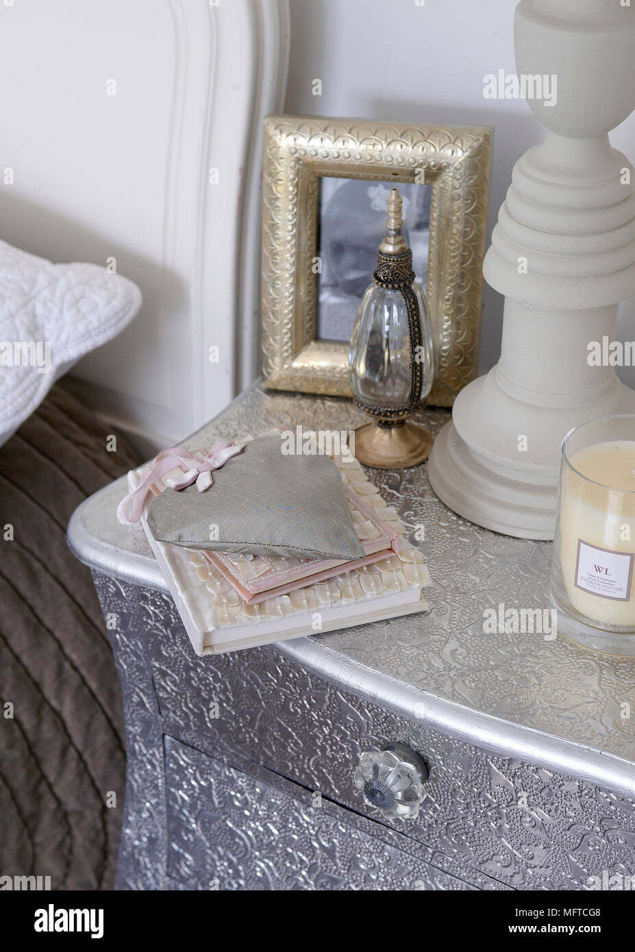 Items on silver bedside chest of drawers Stock Photo