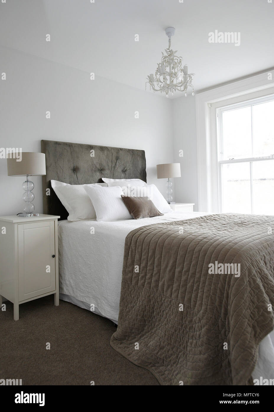 Double bed with upholstered headboard in bedroom Stock Photo Alamy