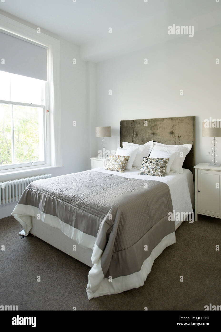 Double bed with upholstered headboard in bedroom Stock Photo Alamy
