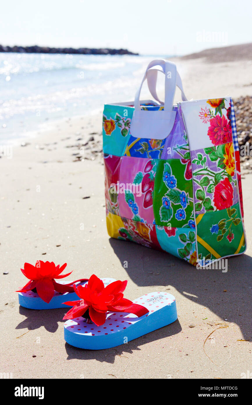 Beach bag ant flip-flops on beach Stock Photo - Alamy