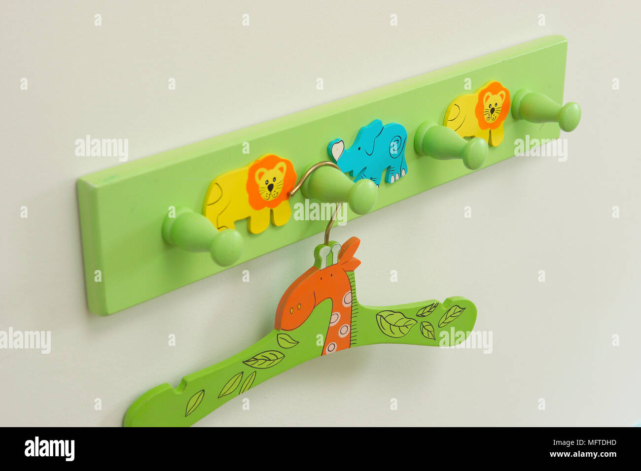 Coat hanger on peg rail Stock Photo Alamy