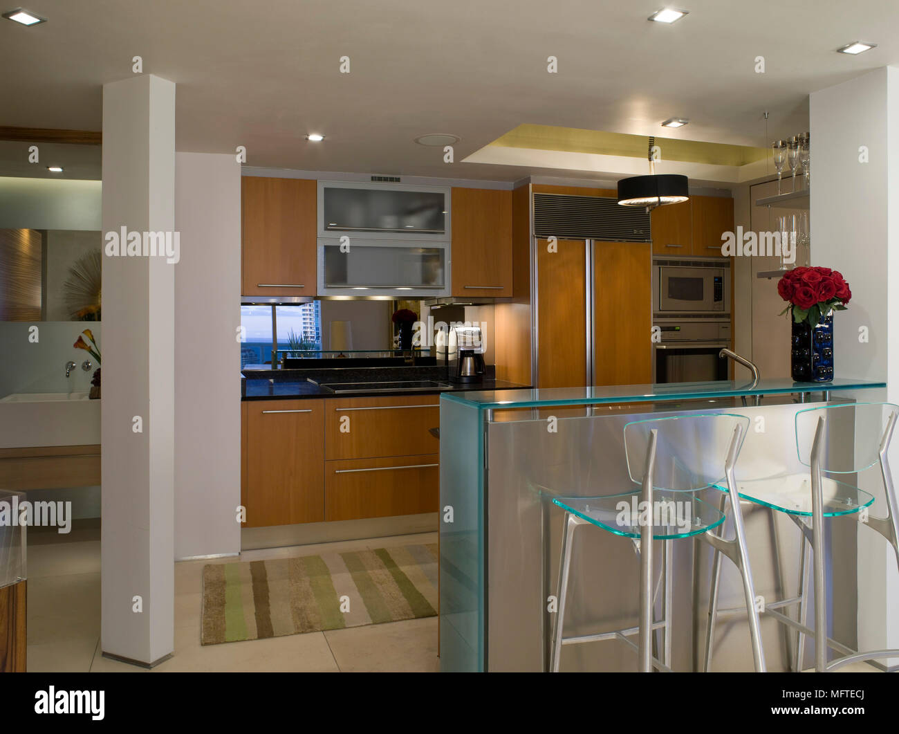 Bar stools at peninsula unit in modern kitchen Stock Photo Alamy