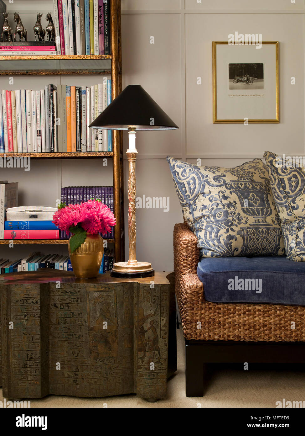 Dressing table next to four poster bed in traditional style bedroom