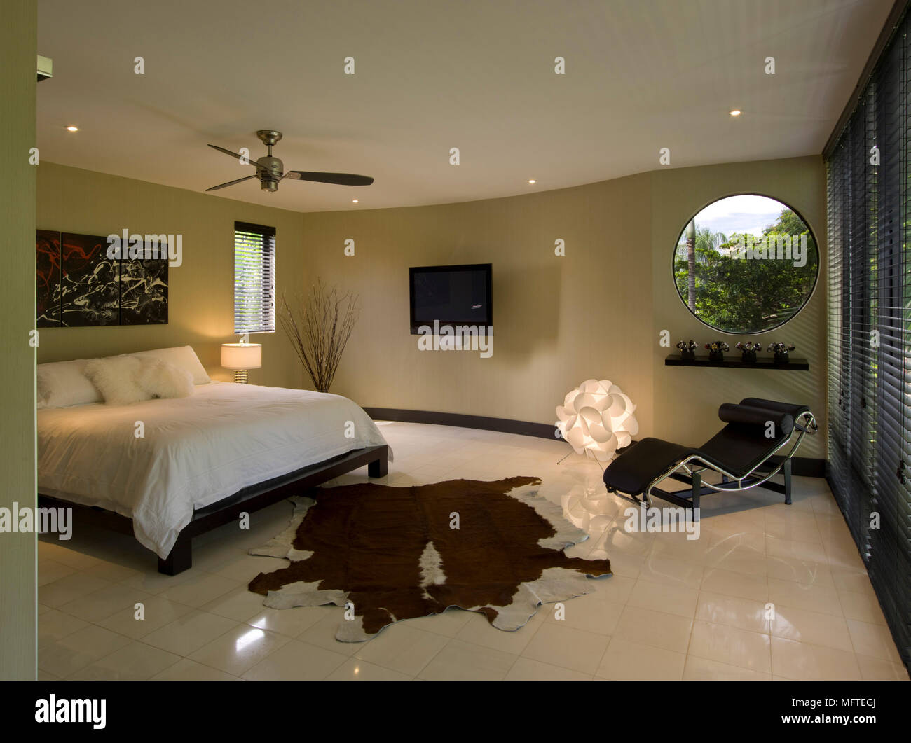 Spacious modern bedroom with le Corbusier recliner facing double bed Stock Photo Alamy