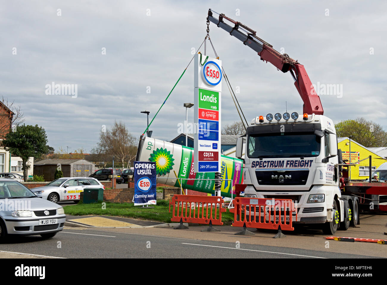 Replacing BP sign with Esso sign at a petrol station in Peterborough, Cambridgeshire, England UK Stock Photo