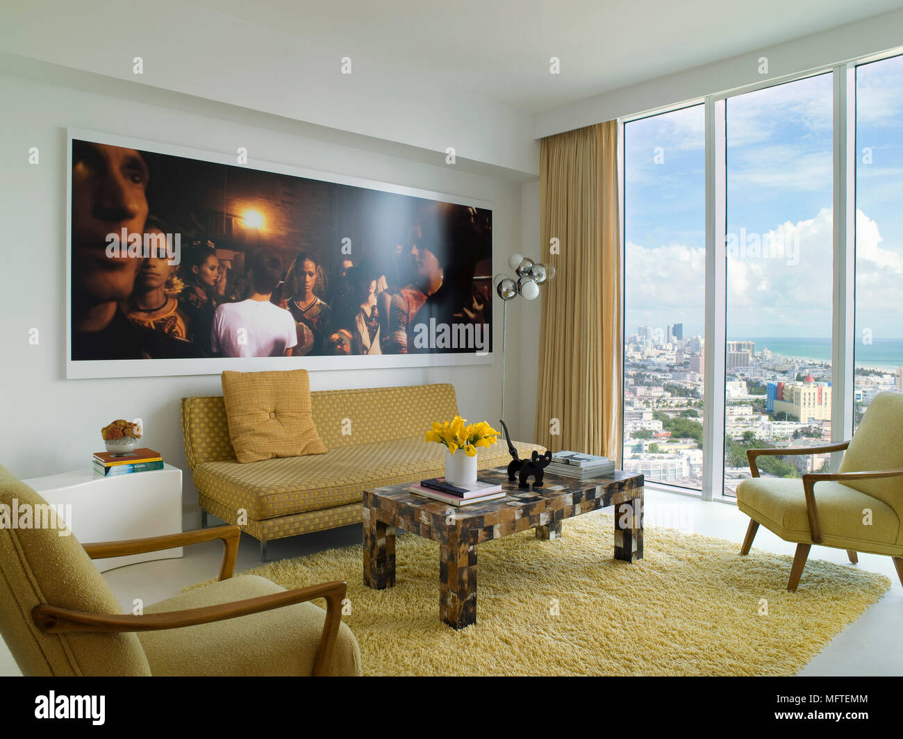 Coffee table in front of gold sofa in modern sitting room Stock Photo ...