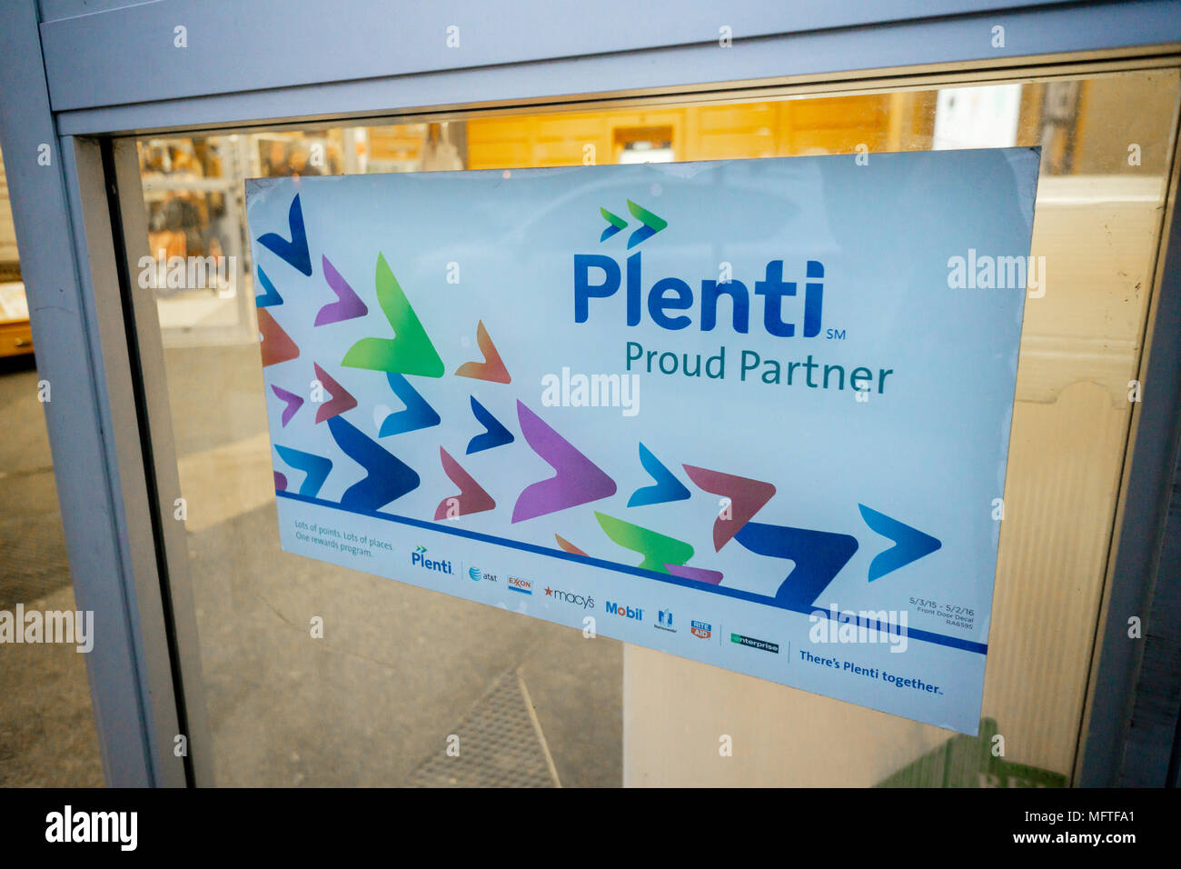 A sign in the entrance to a drugstore in New York informs consumers of the chain's participation in the American Express frequent shopper service, Plenti, seen on Tuesday, April 17, 2018. American Express announced that after the loss of some big brands and general malaise in the program Plenti will cease to operate on July 10 when all customers' Plenti points will expire. (Â© Richard B. Levine) Stock Photo