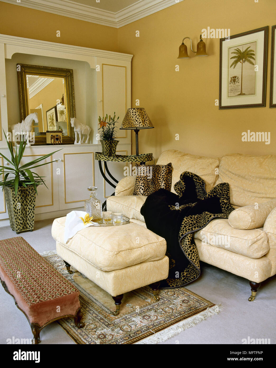 Sitting room with yellow walls and cream sofa with leopard print ...