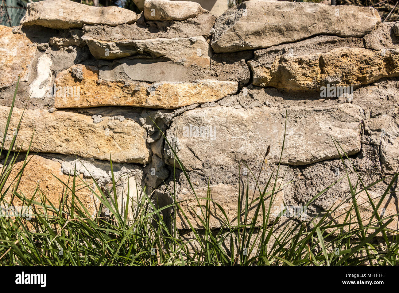 Big stone wall in the garden Stock Photo