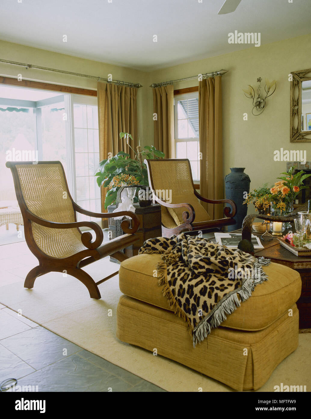 Traditional sitting room with wicker and wood armchairs upholstered ...