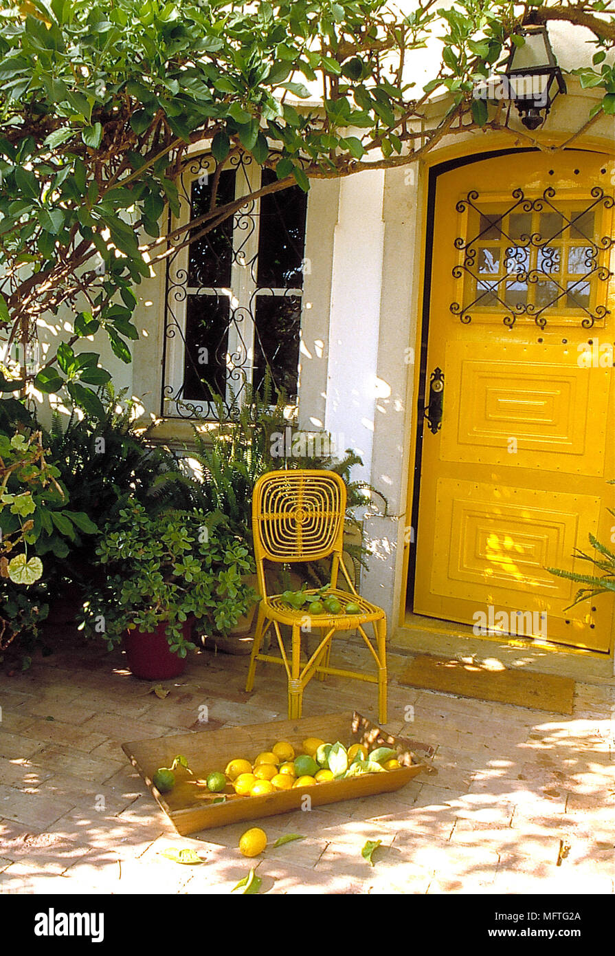 Yellow Chair At Front Door With Limes And Lemons Stock Photo
