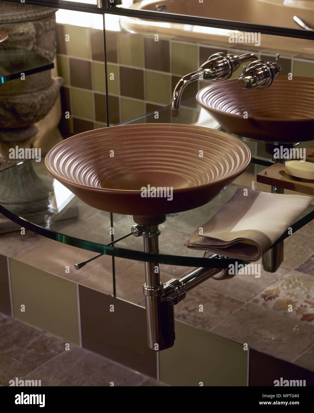Detail of ceramic washbasin set on glass shelf USA Stock Photo