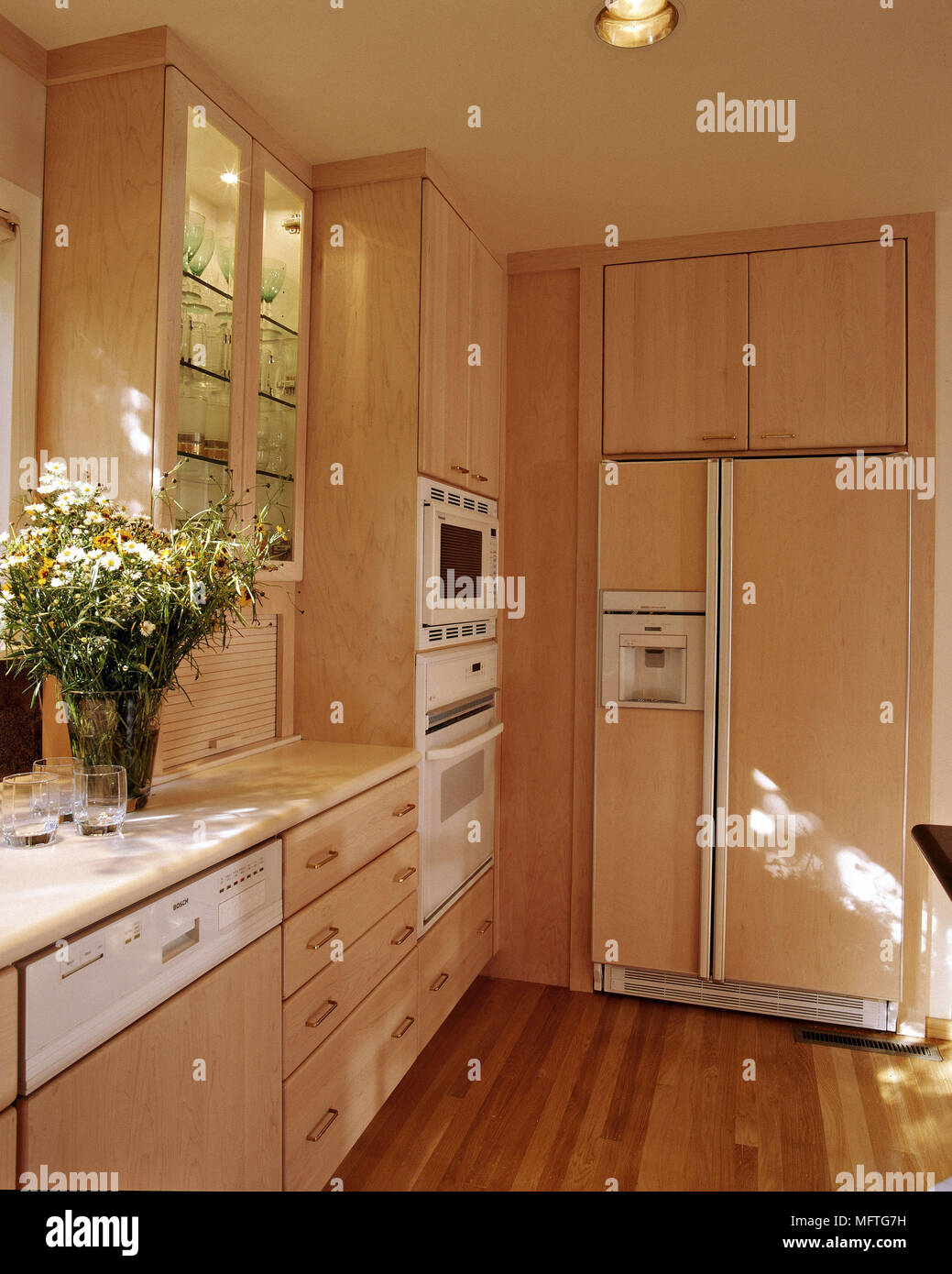 Modern kitchen cream units stainless steel fridge interiors kitchens  appliances Stock Photo - Alamy
