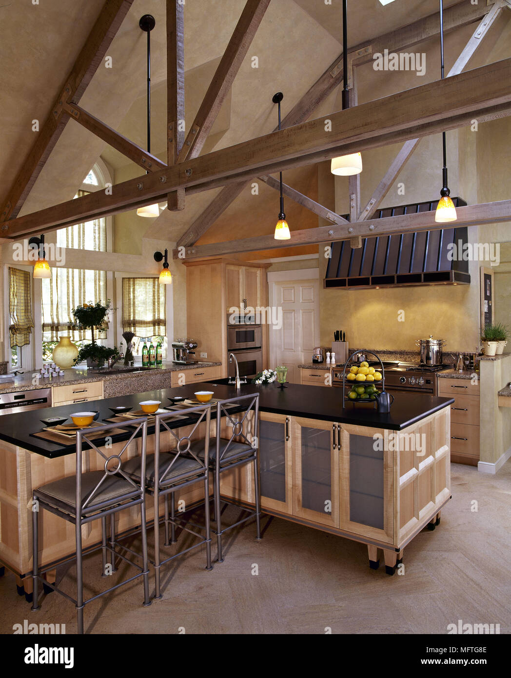 Modern kitchen in converted church with wheeled central island unit ...