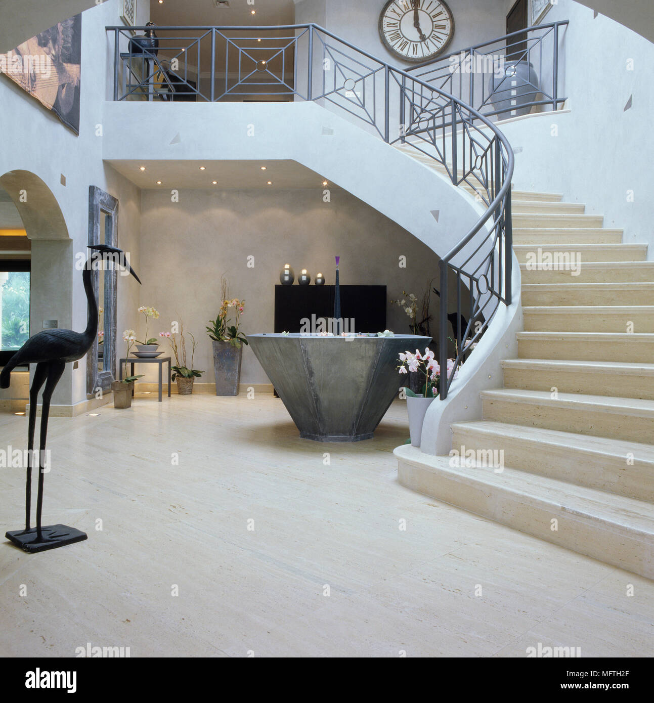 Sweeping staircase with wrought iron banister Stock Photo Alamy