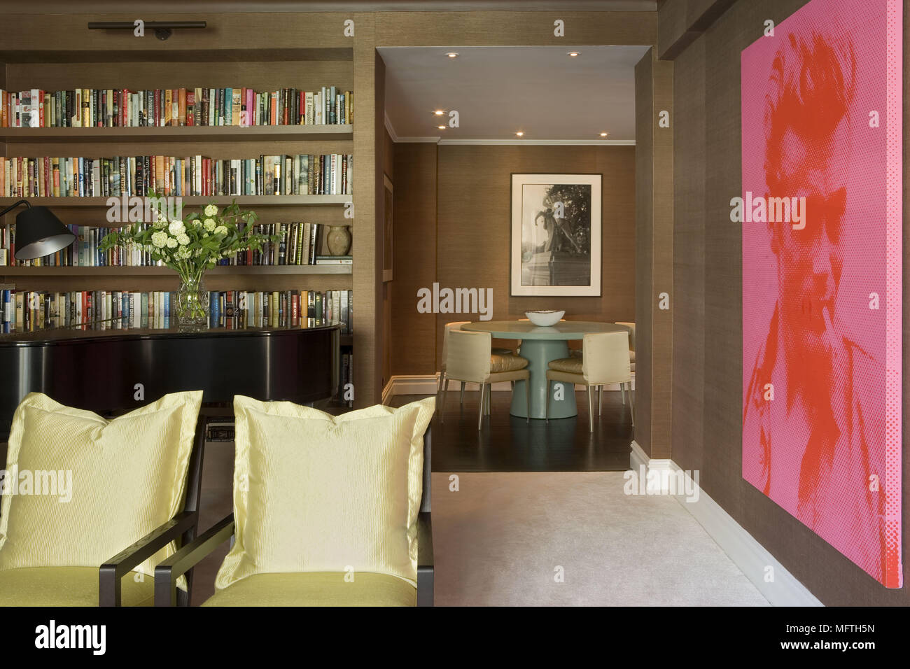 Built In Shelving Next To Open Doorway With View Of Modern Dining