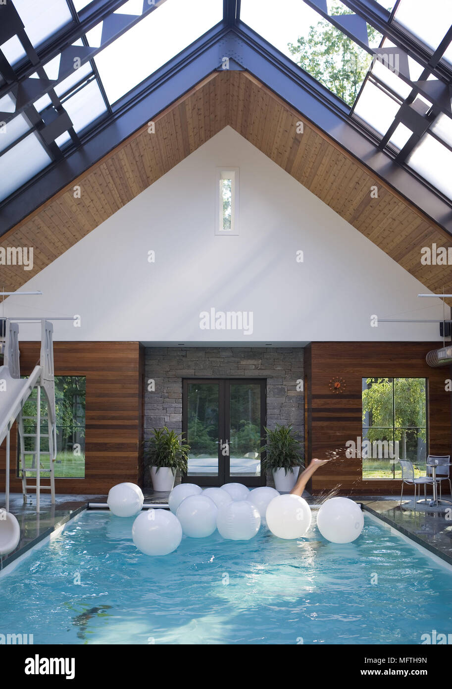 Indoor swimming pool with slide Stock Photo Alamy