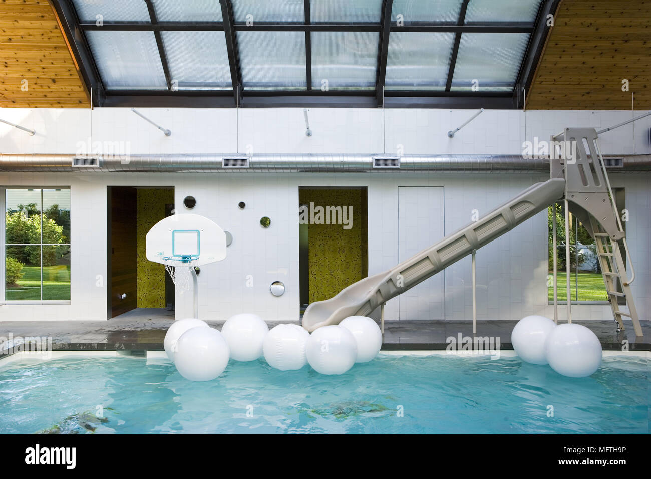 Indoor swimming pool with slide Stock Photo Alamy