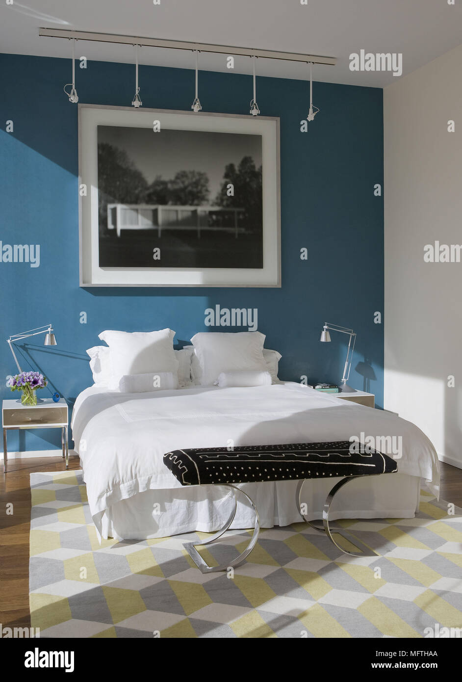 Lamps On Bedside Tables Either Side Of Double Bed In Modern