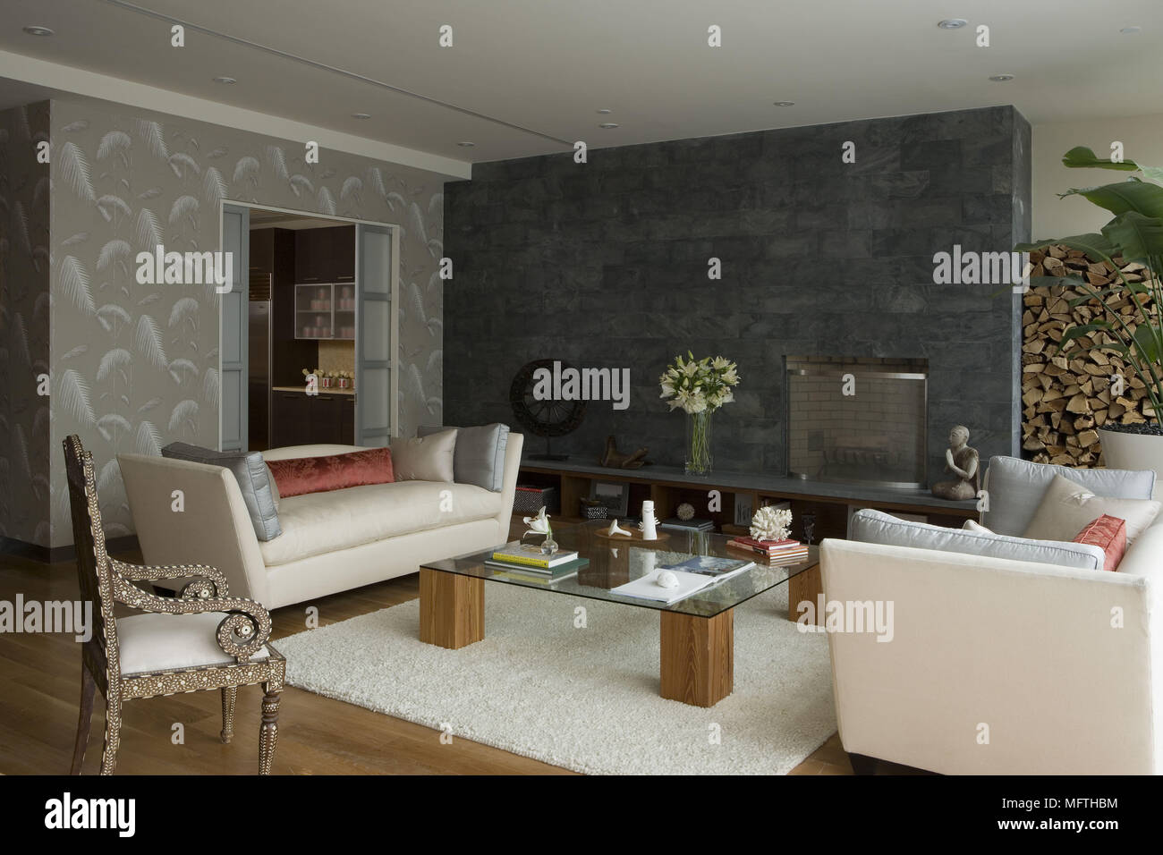 Pair of sofas facing each other across glass topped table in modern